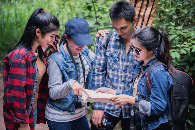 Why Epic Adventure Travel Enhances Student Learning and Development in 2025 1 friends looking map while standing forest 1048944 21328213