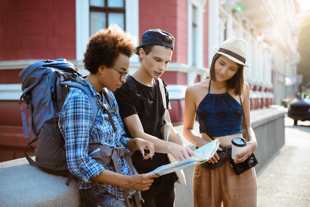 What Are the Best Educational Adventure Destinations in the U. S. in 2025? 2 friends travelers with backpacks smiling looking route map street 176420 6893 1