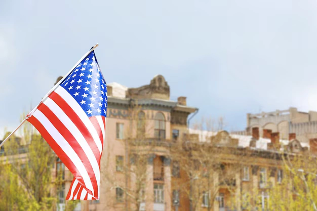 Educational Travel: Best Historical Destinations in the USA 1 waving usa flag blurred building background 392895 239850