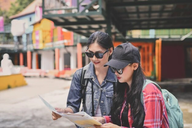 Best Travel Insurance for Student Educational Trips: What You Need to Know 2 young woman with friend reading map 1048944 19901417